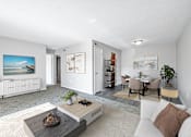 Thumbnail 1 of 15 - A modern living room with a white sofa, a coffee table, and a painting on the wall.