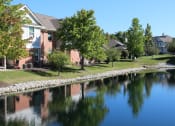 Thumbnail 34 of 35 - a city with a pond in front of it