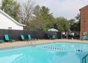 Thumbnail 14 of 17 - a swimming pool with chairs and a fence around it