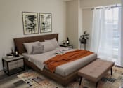 Thumbnail 14 of 18 - A bedroom with a large bed and two framed pictures on the wall.