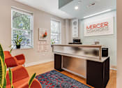 Thumbnail 7 of 23 - A reception area with a Mercer Commons sign on the wall.