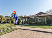 Thumbnail 7 of 15 - a house with a blue flag in front of it
