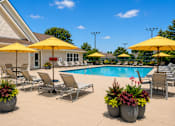 Thumbnail 21 of 21 - A poolside area with yellow umbrellas and lounge chairs.