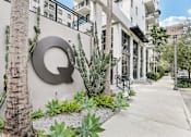 Thumbnail 24 of 33 - A building with a large letter Q on the wall.