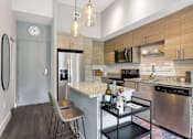Thumbnail 2 of 33 - A kitchen with a stainless steel dishwasher and a white countertop.
