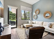 Thumbnail 7 of 33 - A living room with a white couch and a brown chair.