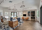 Thumbnail 1 of 18 - A spacious living room with a large wooden coffee table and multiple seating options.
