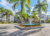 Thumbnail 1 of 29 - A sunny day at a residential area with a pool and palm trees.