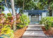Thumbnail 7 of 29 - A pathway leads to a building with a sign that reads
