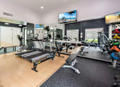 Thumbnail 11 of 29 - A gym with treadmills, exercise bikes, and other equipment.