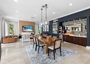 Thumbnail 15 of 29 - A modern dining room with a wooden table and chairs.
