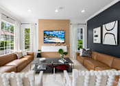 Thumbnail 18 of 29 - A modern living room with a large TV and comfortable seating.