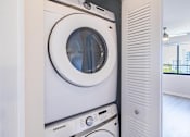 Thumbnail 12 of 33 - A white Samsung washing machine in a modern laundry room.