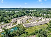 Thumbnail 24 of 33 - A bird's eye view of a residential area with houses and a swimming pool.