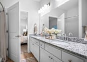 Thumbnail 15 of 33 - A well-lit bathroom with modern cabinetry.