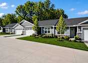 Thumbnail 37 of 47 - A row of houses with a driveway in front.