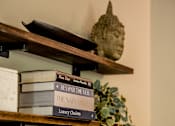 Thumbnail 41 of 47 - A shelf with books and a plant.