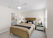 Thumbnail 14 of 26 - A bedroom with a large bed and a ceiling fan.