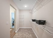 Thumbnail 26 of 26 - A hallway with a carpeted floor and a white wall.