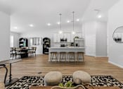 Thumbnail 7 of 26 - A modern kitchen with a dining table and chairs.