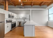 Thumbnail 12 of 22 - Kitchen with wooden floors at Shorehaus Lofts Apartments, Ohio, 44113