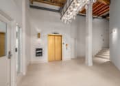 Thumbnail 21 of 22 - Hallway with a chandelier at Shorehaus Lofts Apartments, Cleveland, Ohio