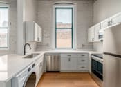 Thumbnail 1 of 22 - Kitchen with white cabinets at Shorehaus Lofts Apartments, Cleveland, 44113