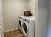 Thumbnail 32 of 33 - A small laundry room with a washer and dryer.
