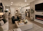 Thumbnail 3 of 38 - A modern living room with a fireplace and a television mounted on the wall.