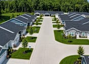 Thumbnail 35 of 47 - A row of houses with a driveway in the middle.
