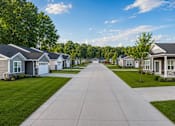 Thumbnail 5 of 47 - A row of houses with a sidewalk in front.