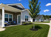 Thumbnail 32 of 47 - A house with a grey siding and a white porch.