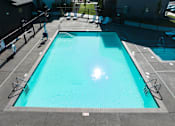 Thumbnail 15 of 31 - A large outdoor swimming pool at Eastpark Apartment Homes, Oregon