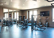 Thumbnail 24 of 31 - A gym with a variety of equipment including treadmills, weights, and exercise machines.at Eastpark Apartment Homes, Salem, OR 97301