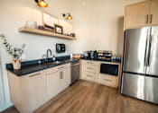 Thumbnail 6 of 31 - A modern kitchen with wooden cabinets and a stainless steel refrigerator.at Eastpark Apartment Homes, Salem