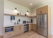 Thumbnail 3 of 51 - A kitchen with wooden cabinets and stainless steel appliances.
