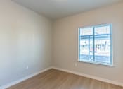 Thumbnail 32 of 51 - Empty room with a window overlooking a parking lot.