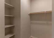 Thumbnail 43 of 51 - A white closet with a hanger on the right side.