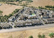 Thumbnail 1 of 82 - A bird's eye view of a residential area with houses and a swimming pool.