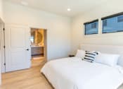 Thumbnail 13 of 82 - A bedroom with a large bed and a mirror on the wall.