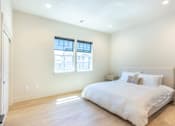 Thumbnail 14 of 82 - A bedroom with a large bed and a window.