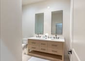 Thumbnail 17 of 82 - A bathroom with a vanity and a toilet.