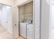 Thumbnail 19 of 82 - A white laundry room with a washer and dryer in it.