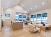 Thumbnail 2 of 82 - A spacious kitchen with a dining area and a living room with a couch and a coffee table.