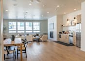 Thumbnail 21 of 82 - A modern kitchen with a dining table and chairs.