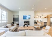 Thumbnail 25 of 82 - A modern living room with a fireplace and a painting on the wall.