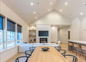 Thumbnail 4 of 82 - A modern dining room with a wooden table and chairs.