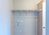 Thumbnail 40 of 82 - A white wall with a shelf and a door.