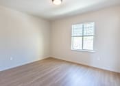 Thumbnail 48 of 82 - A room with a window and wooden flooring.