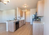 Thumbnail 62 of 82 - A kitchen with wooden cabinets and a white counter top.